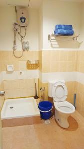 a bathroom with a toilet and a bath tub at AlRayani Guest Room, Homestay Kota bharu in Kota Bharu