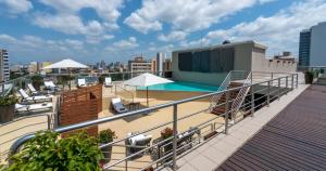 a balcony with a swimming pool on top of a building at Hotel Avenida in Maputo