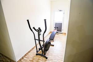 a gym with two exercise bikes in a room at Jeyads Lodge in Tamale