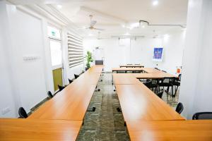 a row of desks in a classroom with tables and chairs at Jeyads Lodge in Tamale