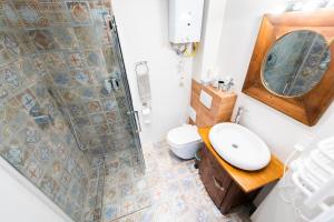 a bathroom with a shower and a sink and a toilet at Old Town Boutique Rooms in Lublin +13 photos