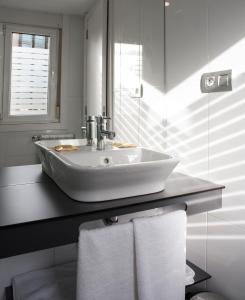 a bathroom with a sink and towels on a counter at Casa Canosa in A Coruña