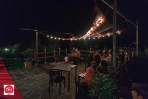 a group of people sitting under a tent at night at Agriturismo Cà Di Rossi in Mulazzo