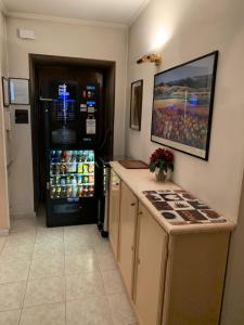 a kitchen with a refrigerator and a counter with a counter sidx sidx sidx at HOTEL ELENA in Turin