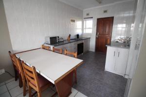 a kitchen with a table and chairs in a room at Dolphin view in Margate
