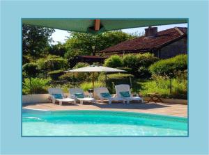 a swimming pool with two chairs and an umbrella at Domaine Charente - Holiday Home with own garden in Mazières