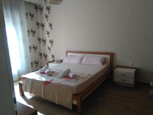 a bedroom with a bed with two dolls on it at Olena House in Kavala