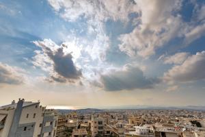 una vista de una ciudad bajo un cielo nublado en Penthouse with Sea View, en Atenas