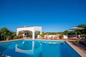 a swimming pool with a gazebo and a swimming pool at CA NA PEPA in Sant Rafael de Sa Creu