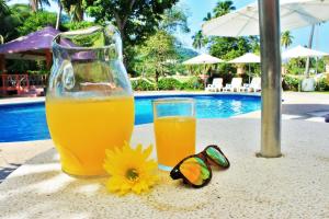 a glass of orange juice and a pair of sunglasses at Coral Ixtapa in Ixtapa