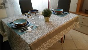 a table with plates and dishes on top of it at Casa SereTina in Rome