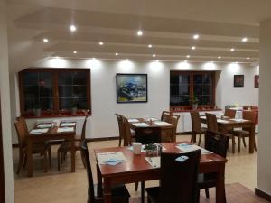 a dining room with wooden tables and chairs at Hotel na Kafkové in Ostrava