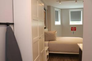 a small bedroom with a bed and a closet at Stylish Studio in Brookline-5min train to Boston.. #2 in Brookline