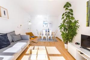 a living room with a couch and a table at Malagueta Blue in Málaga