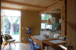 a kitchen with a wooden table and a dining room at Fachwerkhaus am Fluss in Neuhardenberg