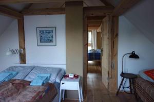 a bedroom with a bed and a table in it at Fachwerkhaus am Fluss in Neuhardenberg