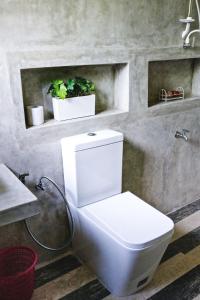 bagno con servizi igienici bianchi e lavandino di Holiday Stay Inn a Kandy