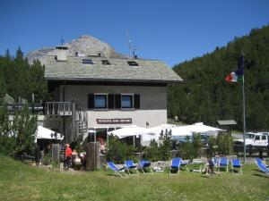a group of lawn chairs and a building with a flag at Chalet Villa Valania in Valdidentro