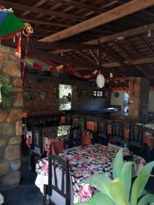 a dining room with a table and some chairs at Pousada Café do Brejo in Triunfo