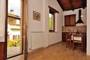 a kitchen with a table and a dining room at Agriturismo Pettino in Campello sul Clitunno