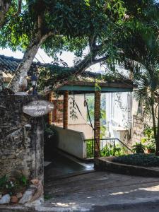 a gate to a house with a tree at Holiday Stay Inn in Kandy