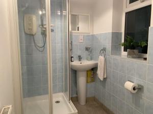 a bathroom with a shower and a sink at 75ers private room in Cheltenham