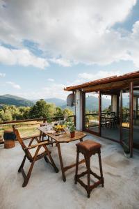 a table and chairs on a patio with a view at Casa Maria Valea Draganului in Lunca Vişagului