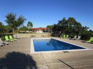 a shadow of a person standing next to a swimming pool at Casa de Campo Vale do Asno in Altura