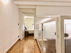 a hallway with white walls and a sliding glass door at Future Apartments in Milan
