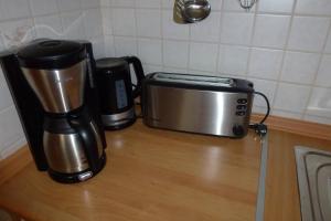 a coffee maker and a toaster sitting on a counter at Ferienwohnung Sauerlandblick in Korbach