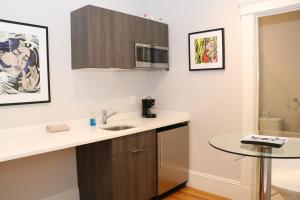 a kitchen with a sink and a table at A Stylish Stay w/ a Queen Bed, Heated Floors.. #32 in Brookline