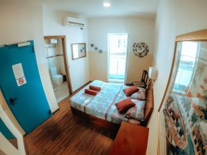 a bedroom with a bed and a blue door at Marco Polo Party Hostel in St. Julianʼs