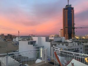 a view of a city skyline at sunset at Marco Polo Party Hostel in St. Julianʼs