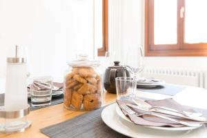 a table with a glass jar of cookies on it at Residence Giulietta in Venice