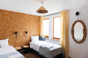 a bedroom with two beds and a mirror at Villa Lulu Piaseczno in Piaseczno