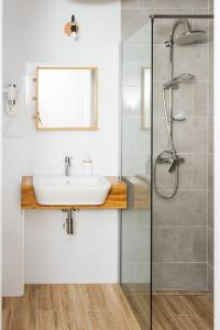 a bathroom with a sink and a shower at Villa Lulu Piaseczno in Piaseczno