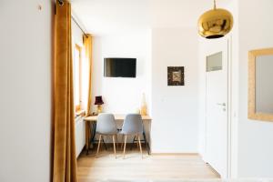 a dining room with two chairs and a table at Villa Lulu Piaseczno in Piaseczno