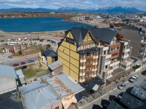 an aerial view of a city with a yellow building at Los Naranjos in Ushuaia