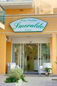 a store with a sign on the front of a building at Residence Suite Smeraldo in Riccione