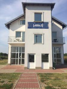 a large white building with a sign on it at Sobe Matea - prenoćište in Vinkovci