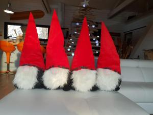 a group of three red christmas trees sitting on a table at Au Bois Flotté in Hourtin