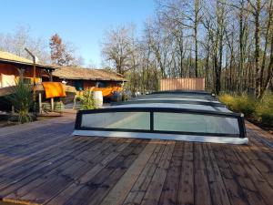 a car parked on top of a wooden deck at Au Bois Flotté in Hourtin