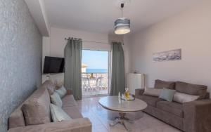 a living room with a couch and a table at Venilia Apartments-4 in Zakynthos