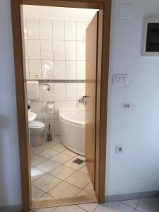 a bathroom with a tub and a toilet and a sink at Marko Apartment in Korčula +24 photos
