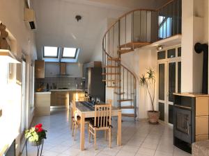 a kitchen with a table and chairs and a staircase at Marko Apartment in Korčula