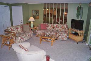 a living room with couches and a flat screen tv at Thunder Island 67B in Ocean City
