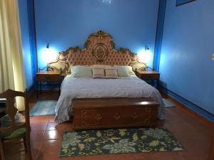 a bedroom with a large bed with two night stands at Hacienda San Pedro Nohpat in Mérida