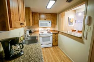 a kitchen with a sink and a stove at Columbine North Star Condo: Close To Everything in Breckenridge +28 photos