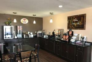 a kitchen with a counter and a table and a counter top at Super 8 by Wyndham Terrell in Terrell