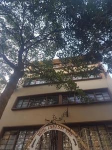 a building with a clock on the side of it at Hotel Embassy in Nairobi